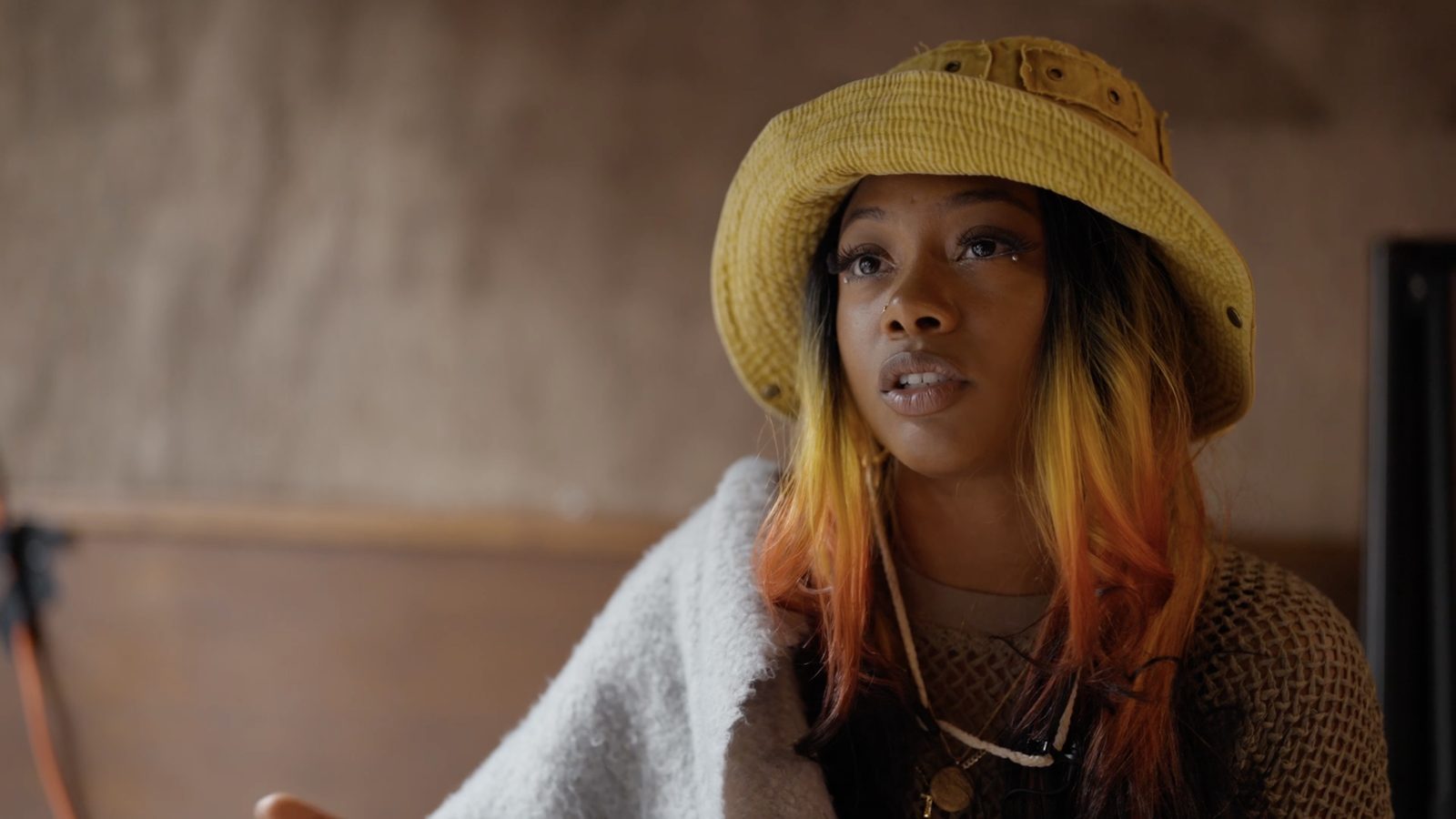 a woman in a yellow bucket hat
